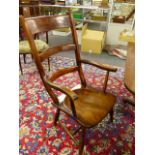 A LARGE VICTORIAN LADDER BACK KITCHEN ARMCHAIR.