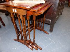A NEST OF THREE TABLES WITH TOOLED LEATHER TOPS.