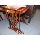 A NEST OF THREE TABLES WITH TOOLED LEATHER TOPS.