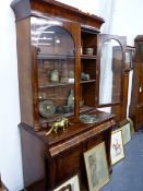 AN EARLY VICTORIAN MAHOGANY BOOKCASE WITH GLAZED DOORS OVER FRIEZE DRAWER AND PANEL DOOR CABINET