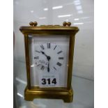 AN EARLY 20th.C.BRASS CASED CARRIAGE CLOCK WITH WHITE ENAMEL DIAL.