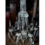 A LATE GEORGIAN STYLE EIGHT LIGHT CHANDELIER. W.66 x H.176cms.