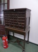 AN EARLY 19th.C.CONTINENTAL WALNUT MULTII DRAWER CHEST RAISED ON BARLEY TWIST SUPPORTS WITH SHAPED X