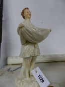 A PORCELAIN FIGURINE.