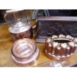 TWO 19th.C.COPPER JELLY MOULDS, A VICTORIAN COPPER KETTLE AND TWO SMALL HAMMERED COPPER DISHES.