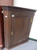 A LATE GEORGIAN OAK CORNER CABINET. W.73 x H.84cms.