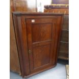 A LATE GEORGIAN OAK CORNER CABINET WITH TWIN PANELLED DOOR. W.65 x H.95cms.