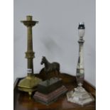 A VICTORIAN GOTHIC BRASS CANDLESTICK, A SILVERPLATED TABLE LAMP AND A BRONZE FIGURE OF A HORSE.