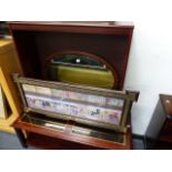 A LARGE OVAL MIRROR, A BOOKCASE, COFFEE TABLE AND A PRINT.