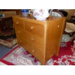 AN OAK CHEST OF DRAWERS.