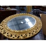 A GILT FRAMED MIRROR.