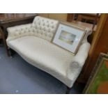 AN EDWARDIAN BUTTON BACK SALON SETTEE.