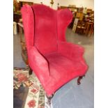 A GEORGIAN STYLE WING BACK ARMCHAIR.