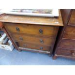 A SMALL OAK CHEST OF DRAWERS AND A WALNUT DRESSING TABLE.