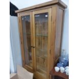 AN OAK DISPLAY CABINET.