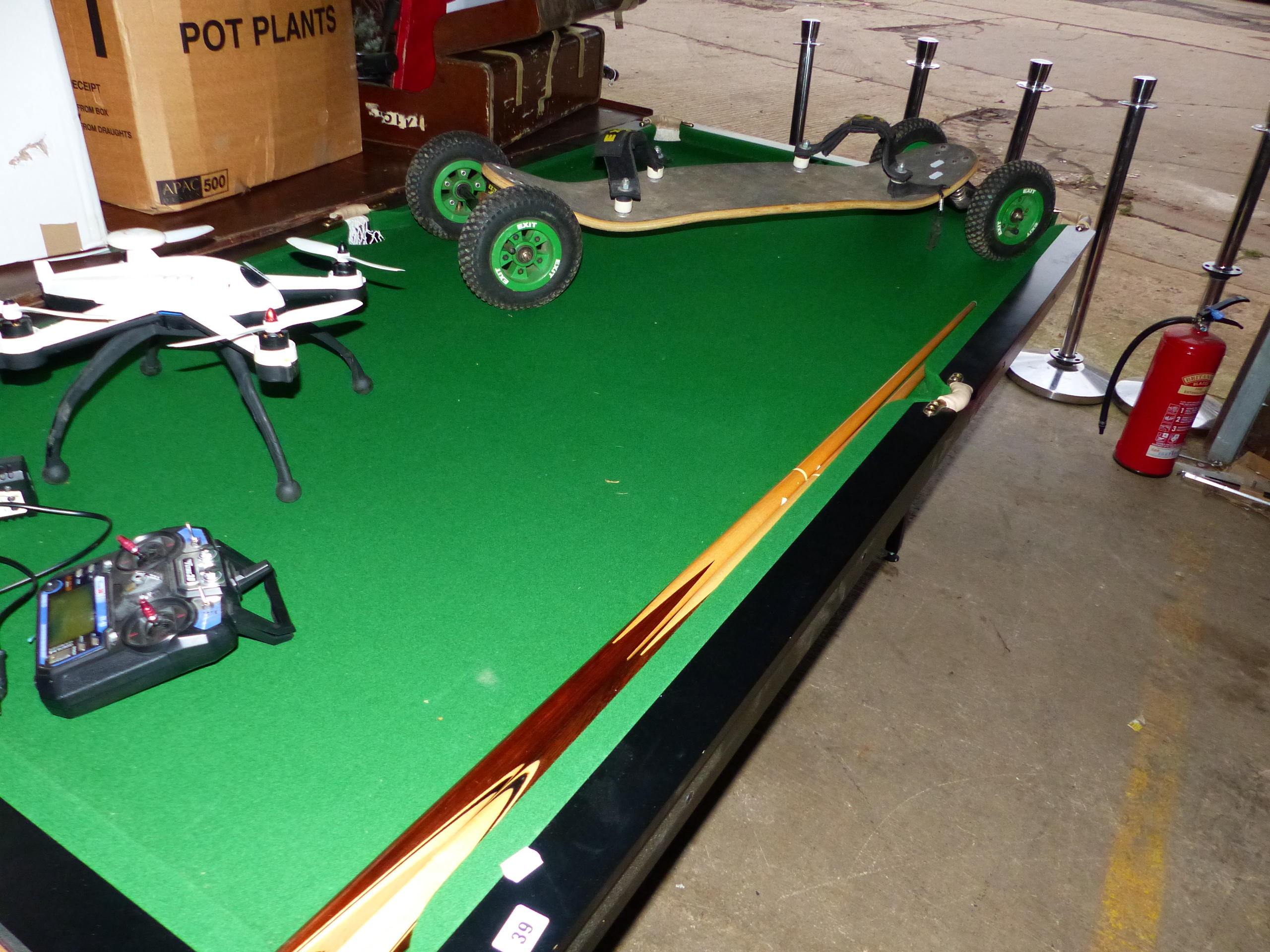 A POOL TABLE IN GREAT CONDITION TOGETHER WITH TWO CUES.