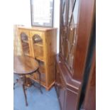 A GLAZED PINE BOOKCASE AND A MAHOGANY CORNER CABINET.