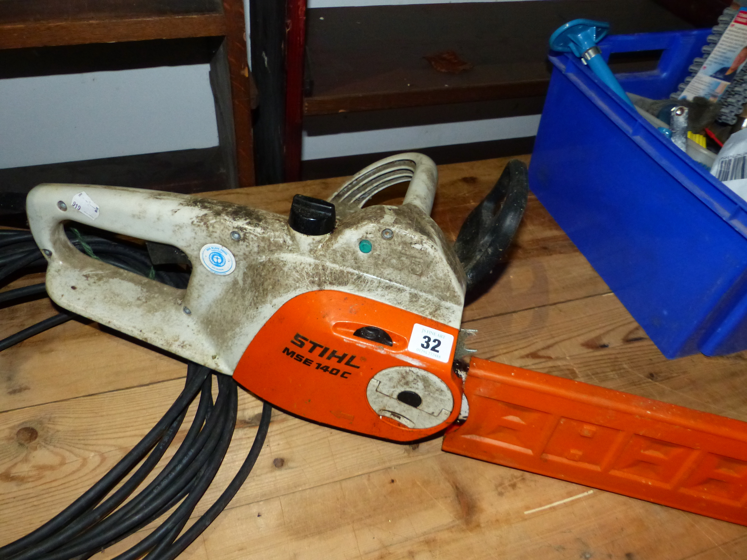 AN ELECTRIC STHIL CHAINSAW AND THREE STRIMMERS.