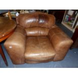 A VERY LARGE LEATHER ARMCHAIR.
