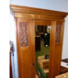 AN EDWARDIAN ASH WARDROBE WITH MIRROR DOOR.