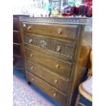 AN OAK CHEST OF DRAWERS.