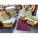 AN ERCOL THREE PIECE SUITE AND A SIMILAR ERCOL STOOL.