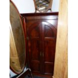 A MAHOGANY CORNER CABINET.