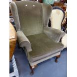 A WING BACK ARMCHAIR.