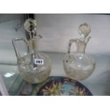 A PAIR OF CUT GLASS CLARET JUGS.