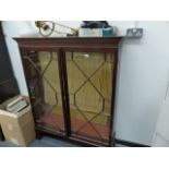 A MAHOGANY GLAZED BOOKCASE.