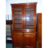 A LATE VICTORIAN MAHOGANY BOOKCASE ON CABINET.