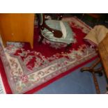 TWO RED GROUND CHINESE RUGS.