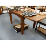 A LARGE HARDWOOD DINING TABLE.