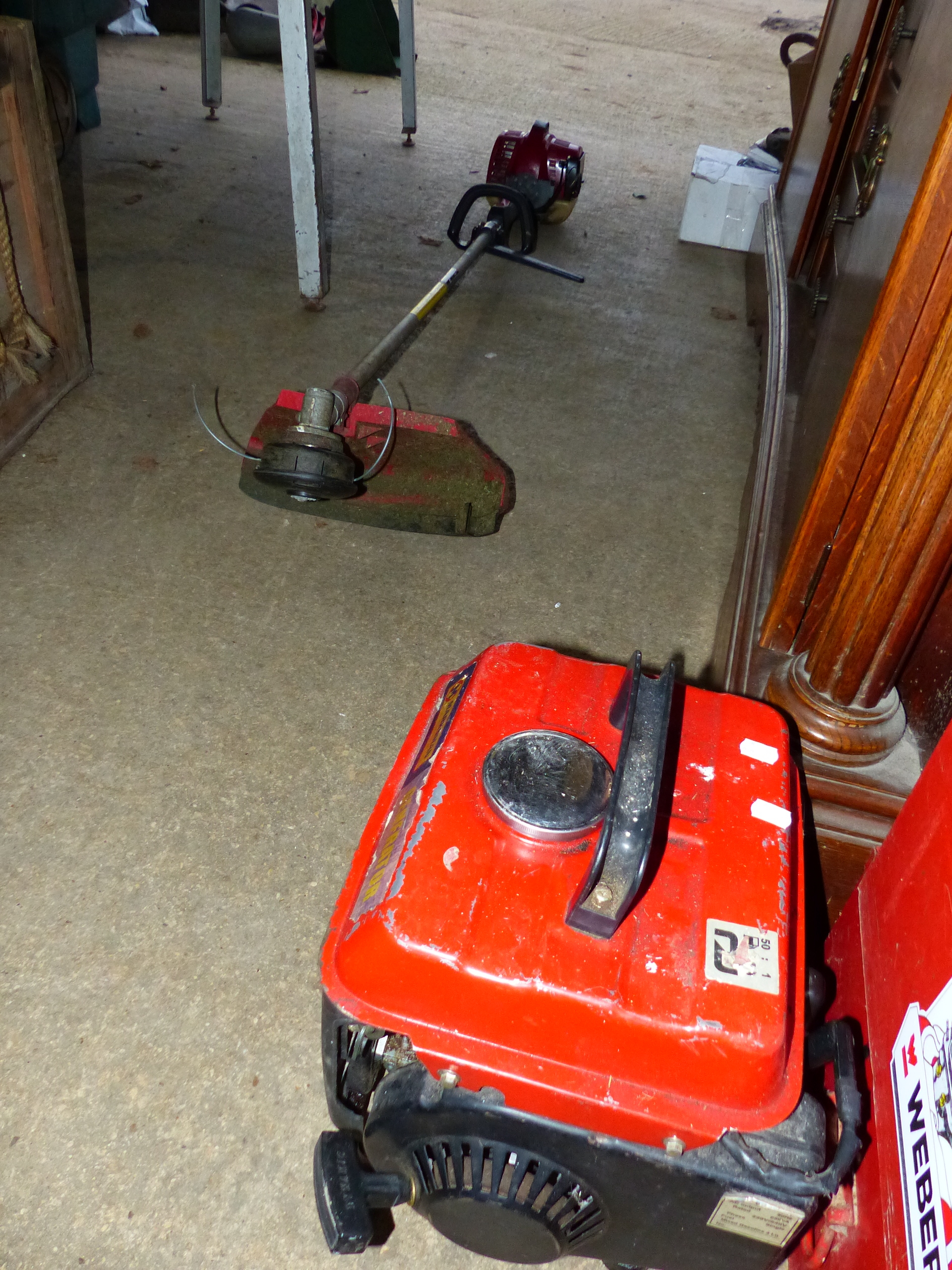 A PETROL STRIMMER AND A SMALL GENERATOR.