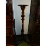 A MAHOGANY TORCHERE.