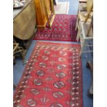 THREE EASTERN PATTERN RUGS.