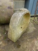 A WEATHERED CARVED STONE BASIN OR FONT.