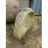 A WEATHERED CARVED STONE BASIN OR FONT.