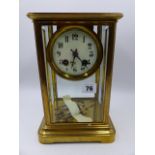 A LATE VICTORIAN/EDWARDIAN BRASS CASED FOUR GLASS TABLE CLOCK WITH 8-DAY MOVEMENT STRIKING ON