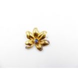 A PRECIOUS YELLOW METAL TESTED AS GOLD SAPPHIRE AND DIAMOND FLOWER BROOCH. THE CENTRAL OVAL SAPPHIRE