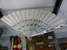 A VICTORIAN INLAID MOTHER OF PEARL AND SILK FAN IN FITTED MAHOGANY SLIDE TOP CASE.