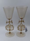 A PAIR OF VENETIAN LARGE WINE GLASSES WITH TWIN SEAHORSE FORM BASES. H.33cms.