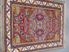 AN ORIENTAL RUG OF CAUCASIAN DESIGN. 194 x 186cms.