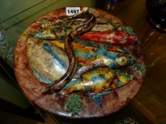 A PORTUGUESE POTTERY FISH AND EEL DECORATED PLATE. Dia.24cms.