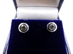 A PAIR OF WHITE METAL RUBOVER SET DIAMOND STUD EARRINGS. APPROXIMATE ESTIMATED DIAMOND WEIGHT 0.