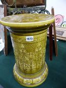 AN ART POTTERY STAND IN OLIVE GREEN GLAZE WITH FLORAL MOTIFS, INDISTINCT IMPRESSED MARKS. H.41cms.