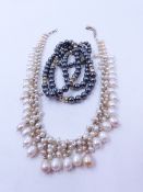 AN 82cm ROW OF HEMATITE BEADS INTERSPERSED WITH GOLD RONDELS AND FROSTED CLEAR BEADS, FINISHED