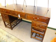 A CHINESE CARVED HARDWOOD TWIN PEDESTAL WRITING TABLE WITH THREE APRON DRAWERS ABOVE FOUR DRAWERS.