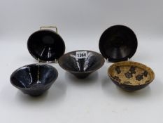 FIVE EARLY CHINESE CONICAL FORM TEA BOWLS IN BLACK AND BROWN GLAZES. LARGEST Dia. 12.5cms.