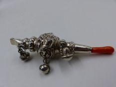 A VICTORIAN BABIES SILVER RATTLE. THE RATTLE FEATURES AN ADDITIONAL WHISTLE AND A PIECE OF